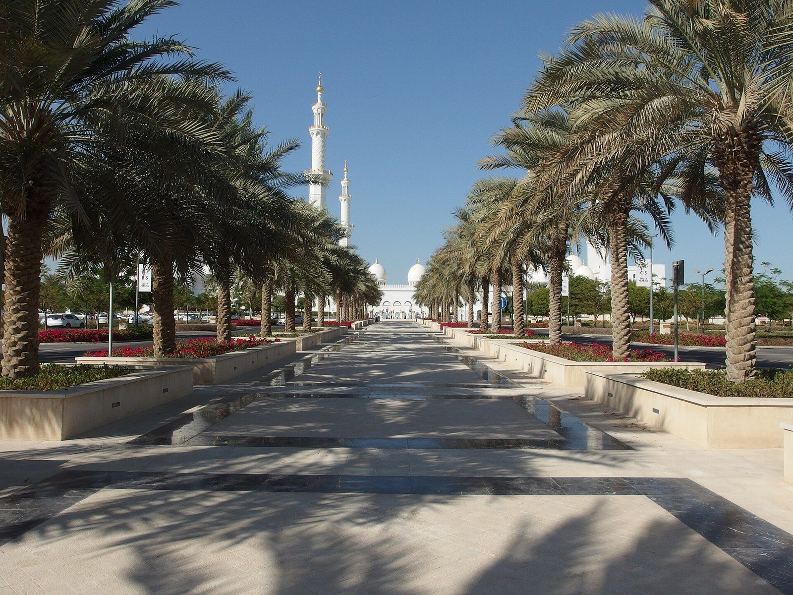 Day trips from Dubai: a palm-lined avenue leads to the white minarets and domes of the Sheikh Zayed Grand Mosque