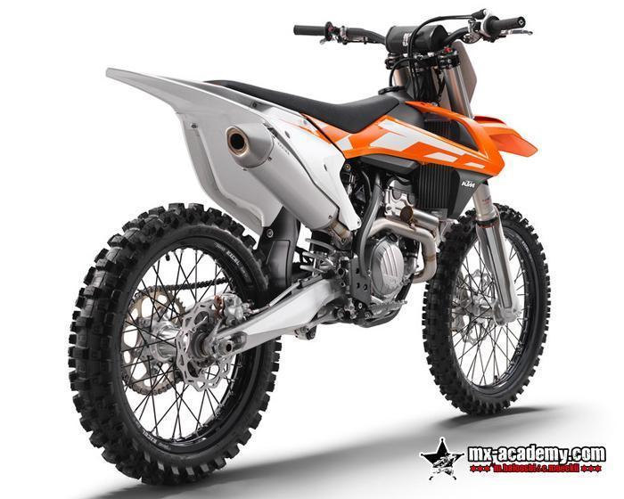 Dirt bike rental in Dubai: orange and white KTM motocross bike seen at an angle from behind, studio photo