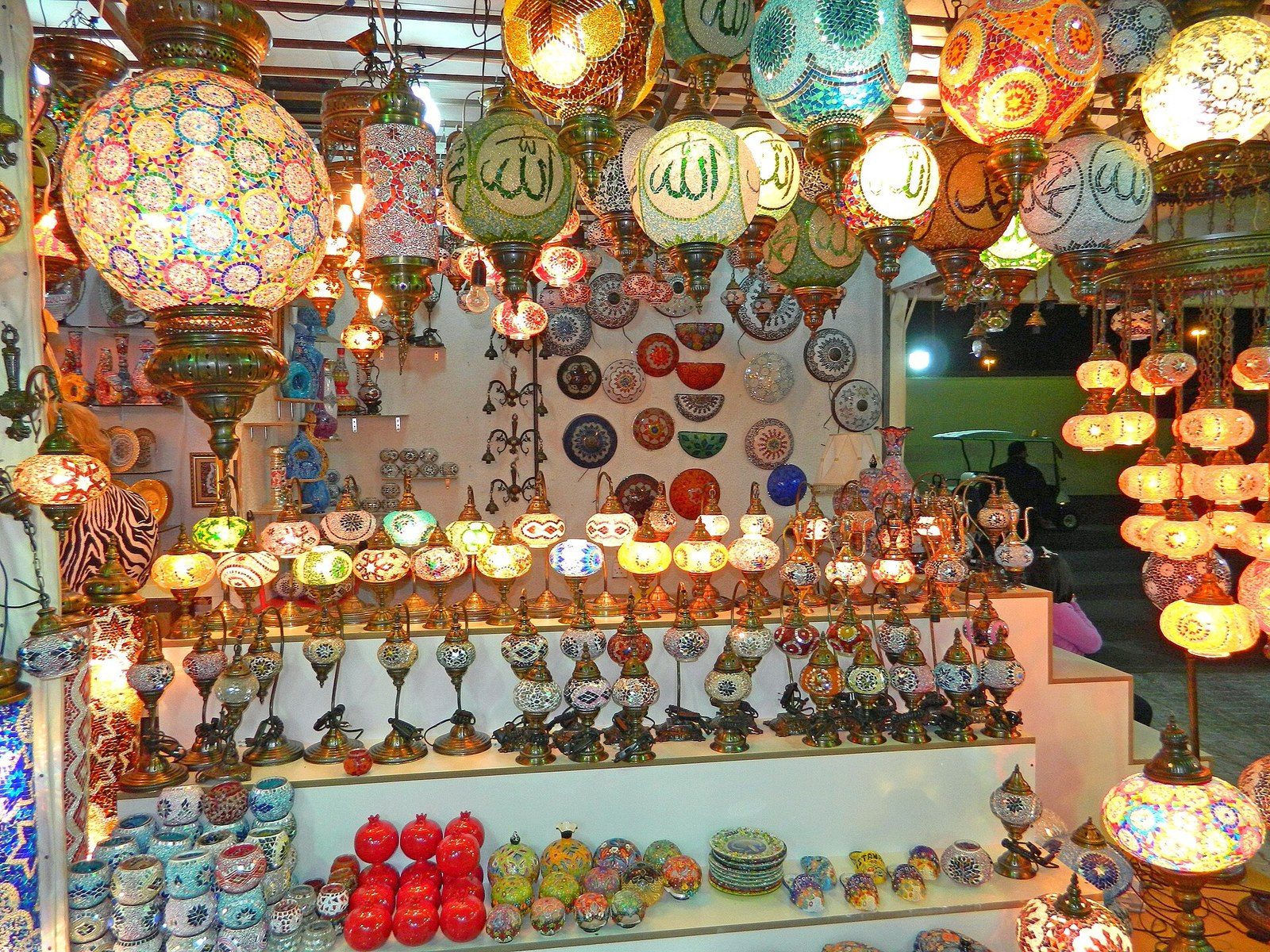 Fun in Dubai with friends: a stall glowing with coloured mosaic lamps, lanterns and painted bowls