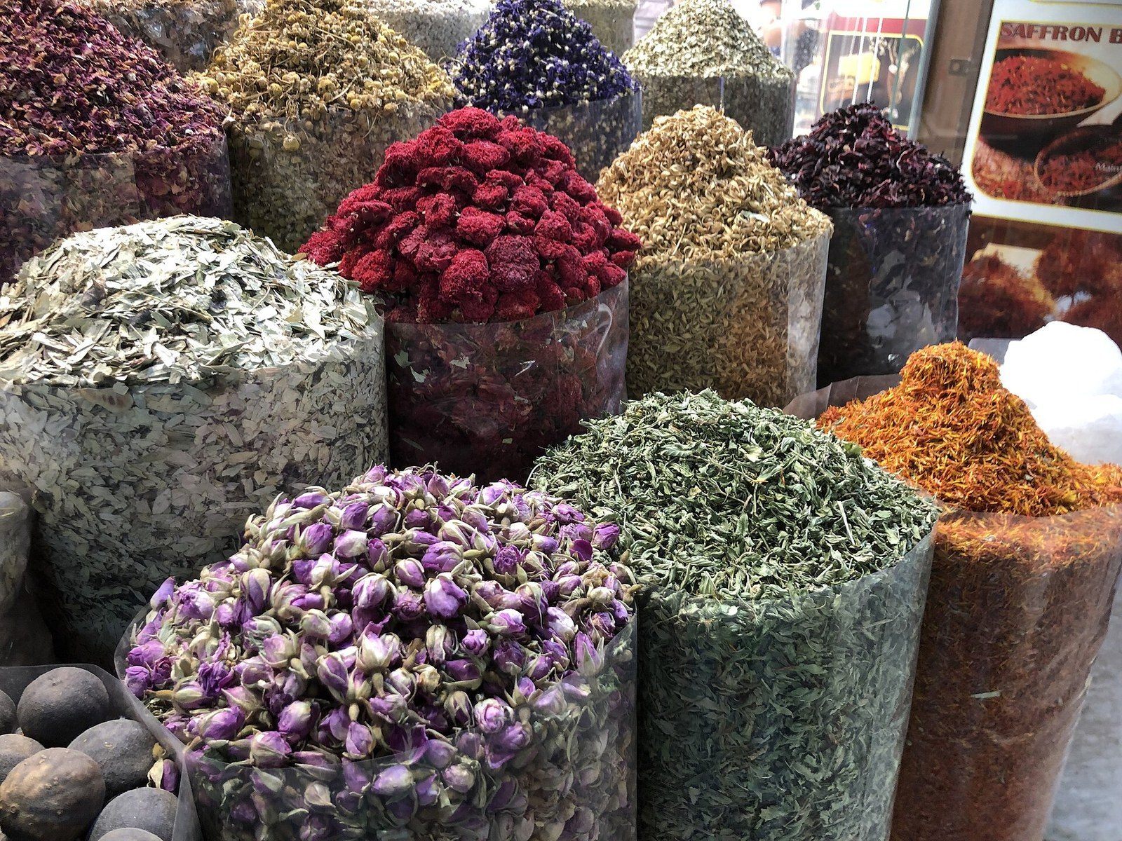 Things to do in Dubai for first-time visitors: open sacks of dried flowers, herbs and spices at a souk stall