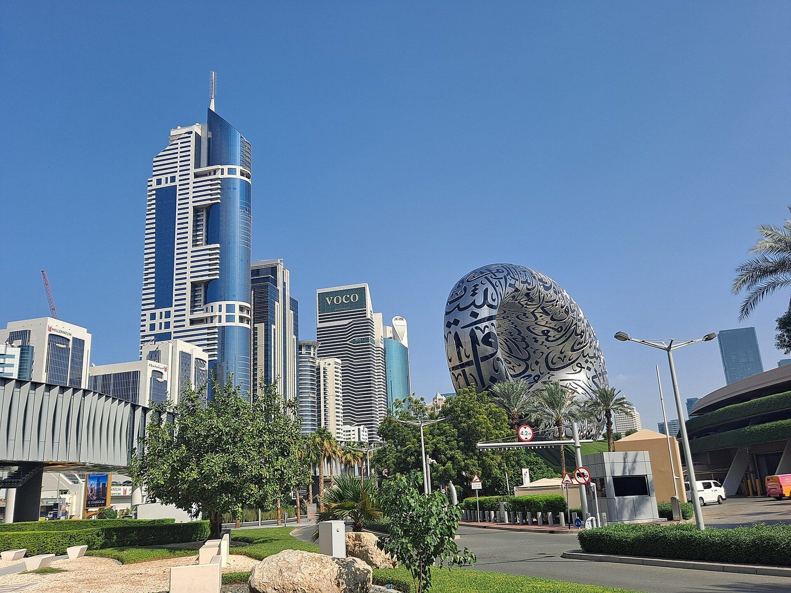 Top attractions in Dubai: the silver, calligraphy-covered ring of the Museum of the Future beside tall towers